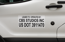 Load image into Gallery viewer, DOT decal on the door of a white production van
